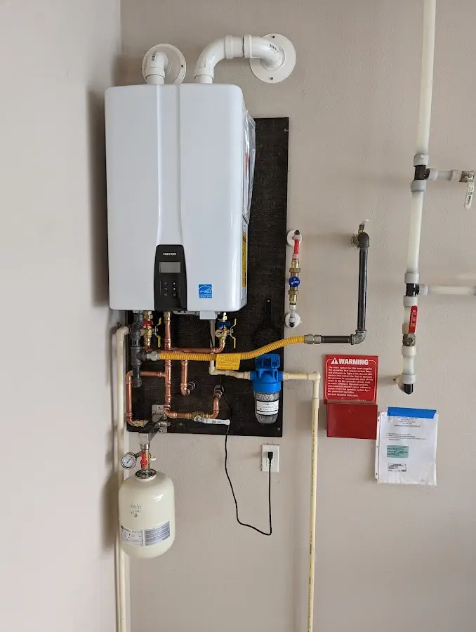 Professional plumber installing copper piping in a Denton home